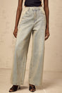 Woman wearing light blue denim jeans decorated with small rhinestones creating a sparkling effect