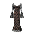 Woman wearing long black flared lace maxi dress with fitted bodice and flowing skirt