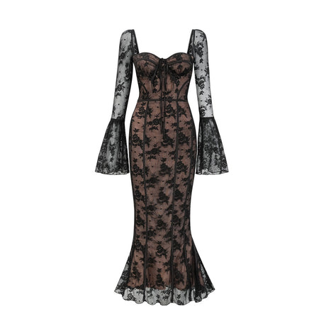 Woman wearing long black flared lace maxi dress with fitted bodice and flowing skirt