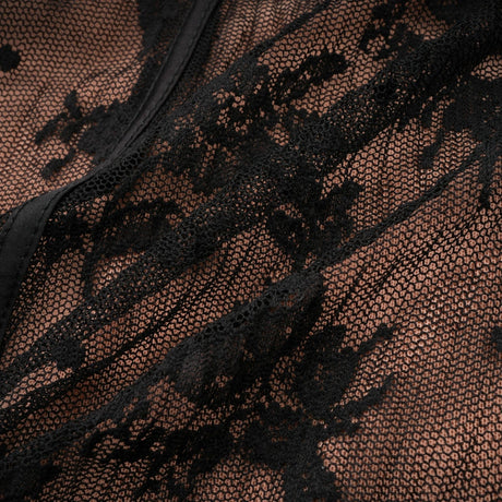 Woman wearing long black flared maxi dress with lace details