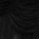 Woman wearing long black maxi dress with one shoulder and side cutout detail