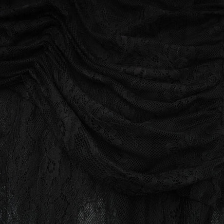 Woman wearing long black maxi dress with one shoulder and side cutout detail