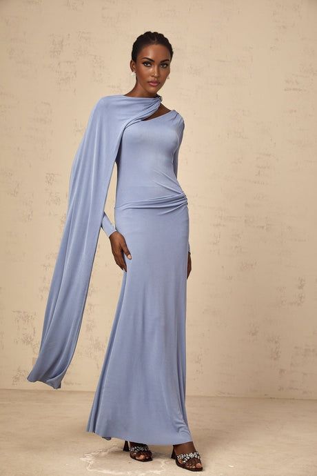 Woman wearing long blue fitted maxi dress with diagonal shawl neckline