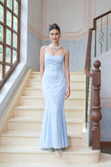 Woman wearing long blue floral jacquard maxi dress with laceup front and flared skirt