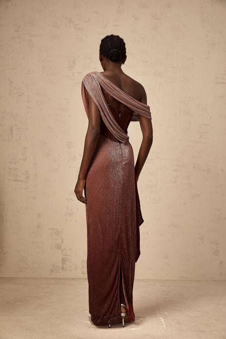 Woman wearing long brown maxi dress with corset top and ribbon design details flowing skirt elegant formal style