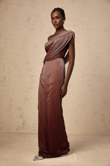 Woman wearing long brown maxi dress with corset top featuring ribbon design and flared skirt