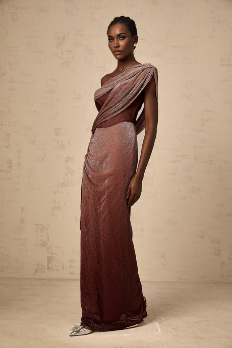 Woman wearing long brown maxi dress with corset top featuring ribbon design and flared skirt