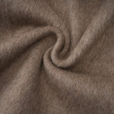 Woman wearing long brown wool cape coat with fur trim and belt