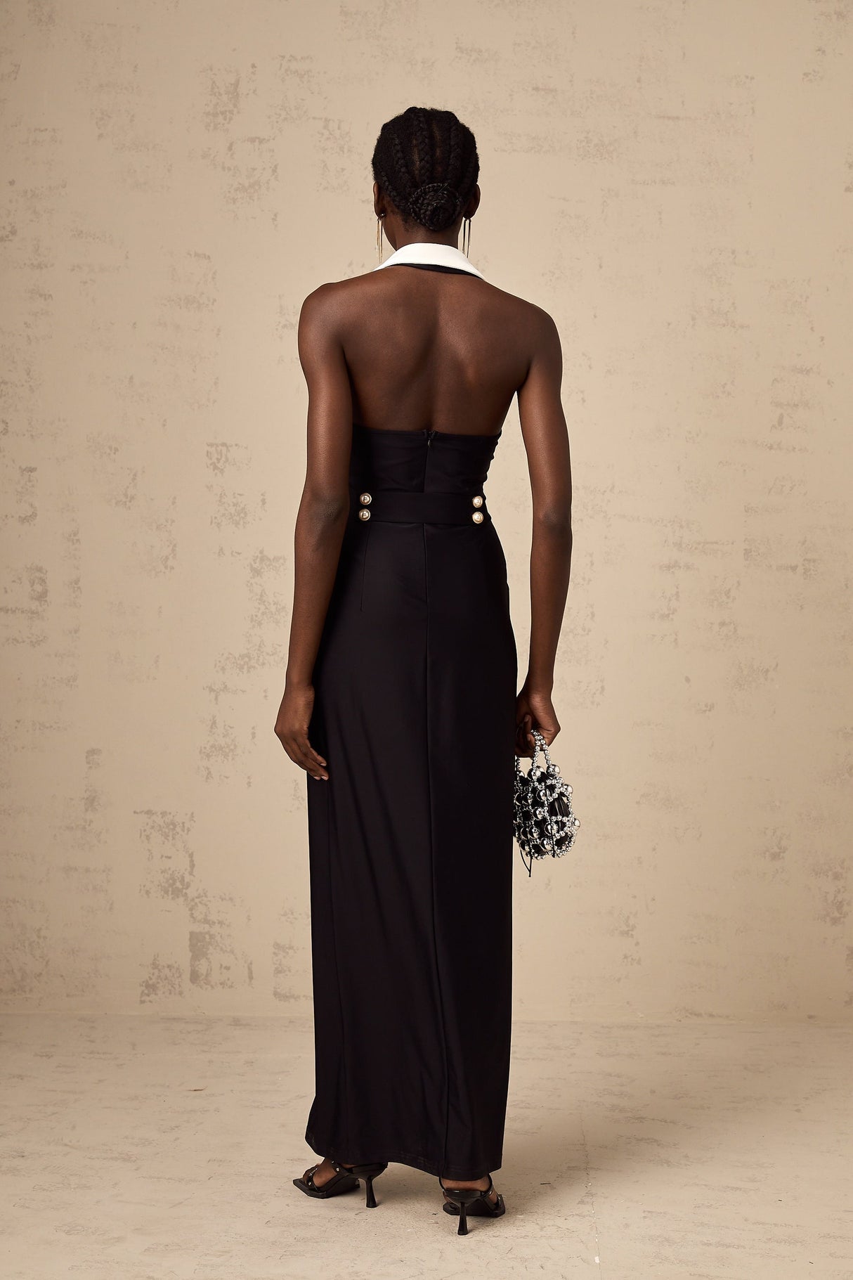 Woman wearing long fitted maxi dress with color block design in contrasting shades
