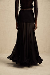 Woman wearing long flowing maxi skirt with ruffles and pleats in soft rayon fabric mixed with tulle layers