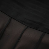 Woman wearing long flowing maxi skirt with ruffles and pleats in tulle fabric