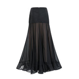 Woman wearing long flowing maxi skirt with ruffles and pleats made of rayon and tulle fabric in a soft pastel color