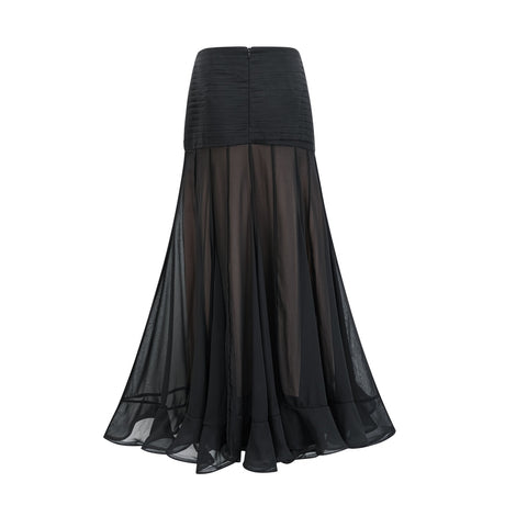 Woman wearing long flowing maxi skirt with ruffles and pleats made of rayon and tulle fabric in a soft pastel color