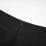 Woman wearing long flowy maxi skirt with ruffles and pleats in soft tulle fabric