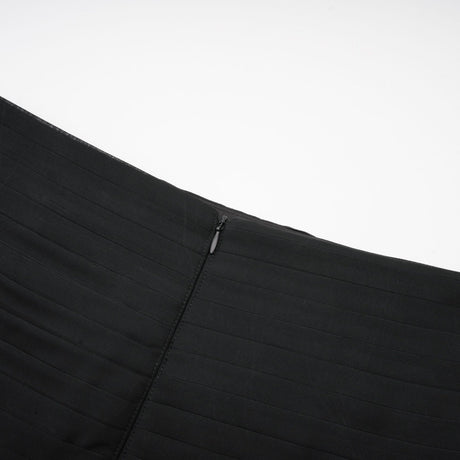 Woman wearing long flowy maxi skirt with ruffles and pleats in soft tulle fabric