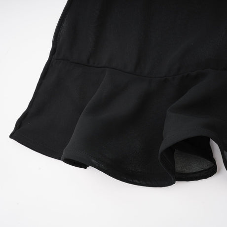 Woman wearing long flowy maxi skirt with ruffles and pleats in soft tulle fabric