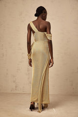 Woman wearing long gold maxi dress with ribbon design and gathered fabric elegant evening gown