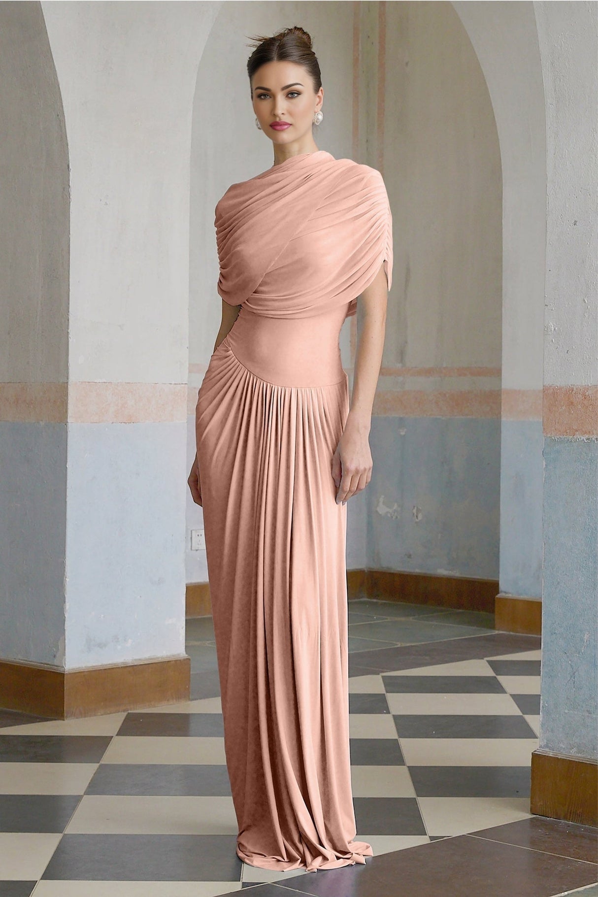 Woman wearing long pink asymmetric maxi dress with pleated skirt and flowing design