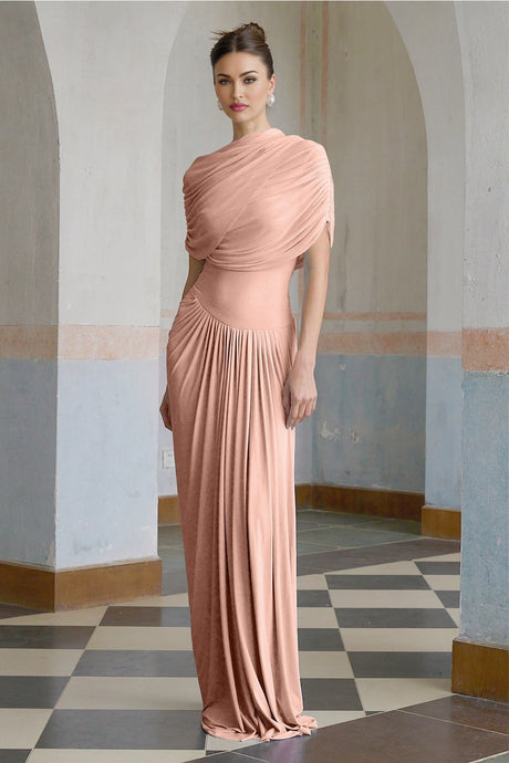 Woman wearing long pink asymmetric maxi dress with pleated skirt and flowing design