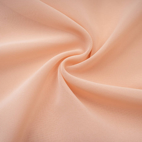 Woman wearing long pink chiffon maxi dress with ruffle details and halter neck style Mariah dress shown in full length view