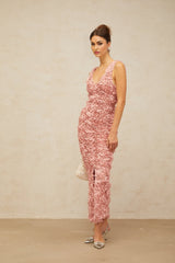 Woman wearing long pink floral maxi dress with V neckline and floral pattern