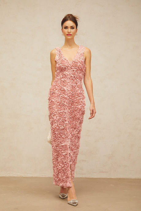Woman wearing long pink floral maxi dress with Vneck and faux flower pattern