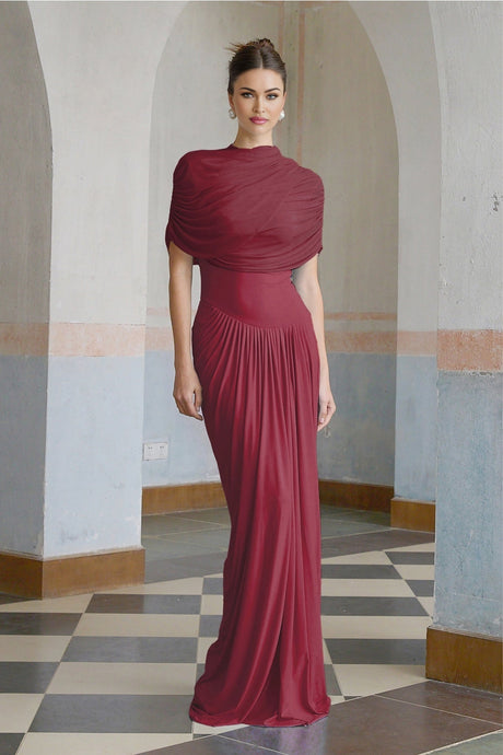 Woman wearing long red asymmetric pleated maxi dress with one shoulder strap