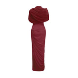 Woman wearing long red asymmetric pleated maxi dress with one shoulder strap
