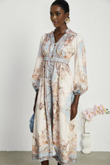 Woman wearing long sleeve floral print dress with bohemian style and flowing skirt