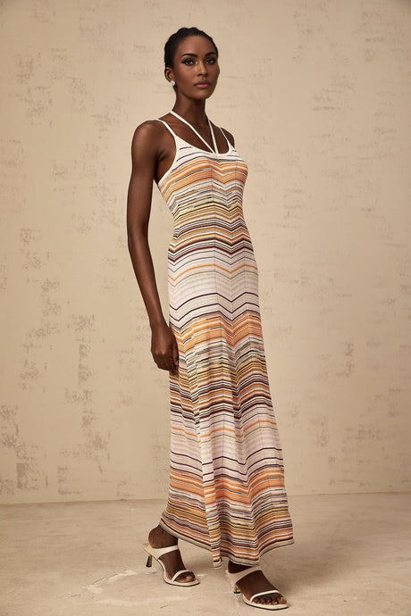 Woman wearing long striped knit maxi dress in multiple colors by Chloe