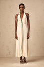 Woman wearing long white maxi dress with deep V neckline and draped fabric detail