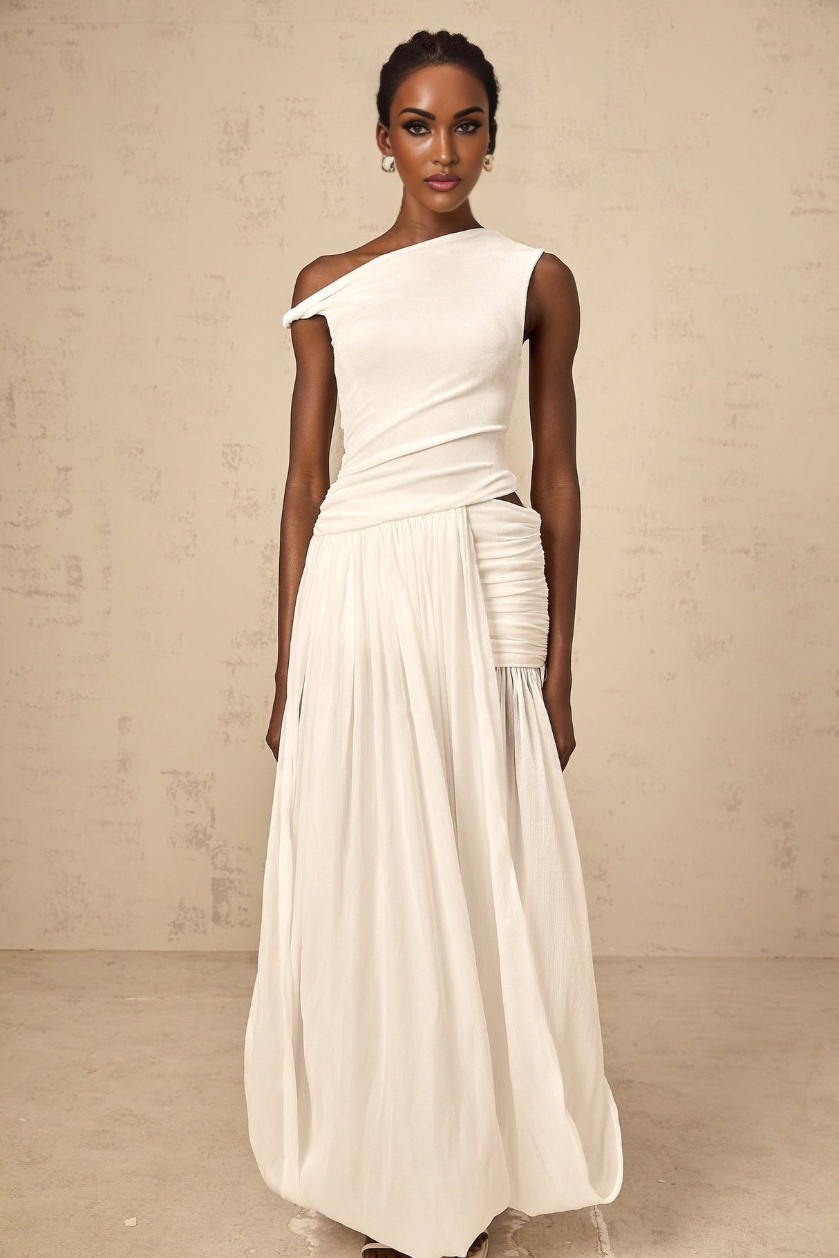 Woman wearing long white maxi dress with single shoulder strap and shirred panel detailing