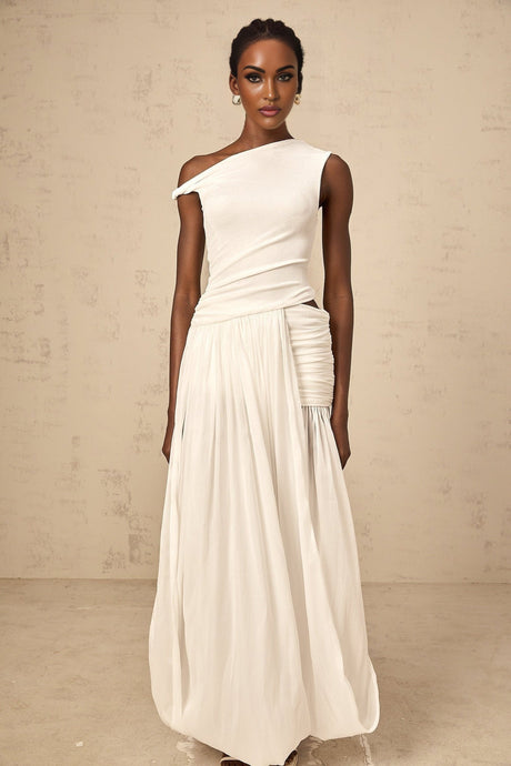 Woman wearing long white maxi dress with single shoulder strap and shirred panel detailing