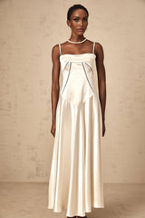 Woman wearing long white satin maxi dress with flared skirt