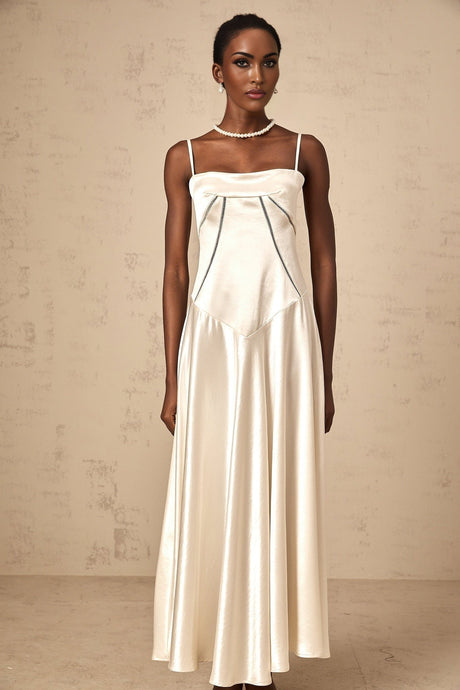 Woman wearing long white satin maxi dress with flared skirt