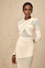 Woman wearing long white tulle maxi dress with ruched details and thin straps