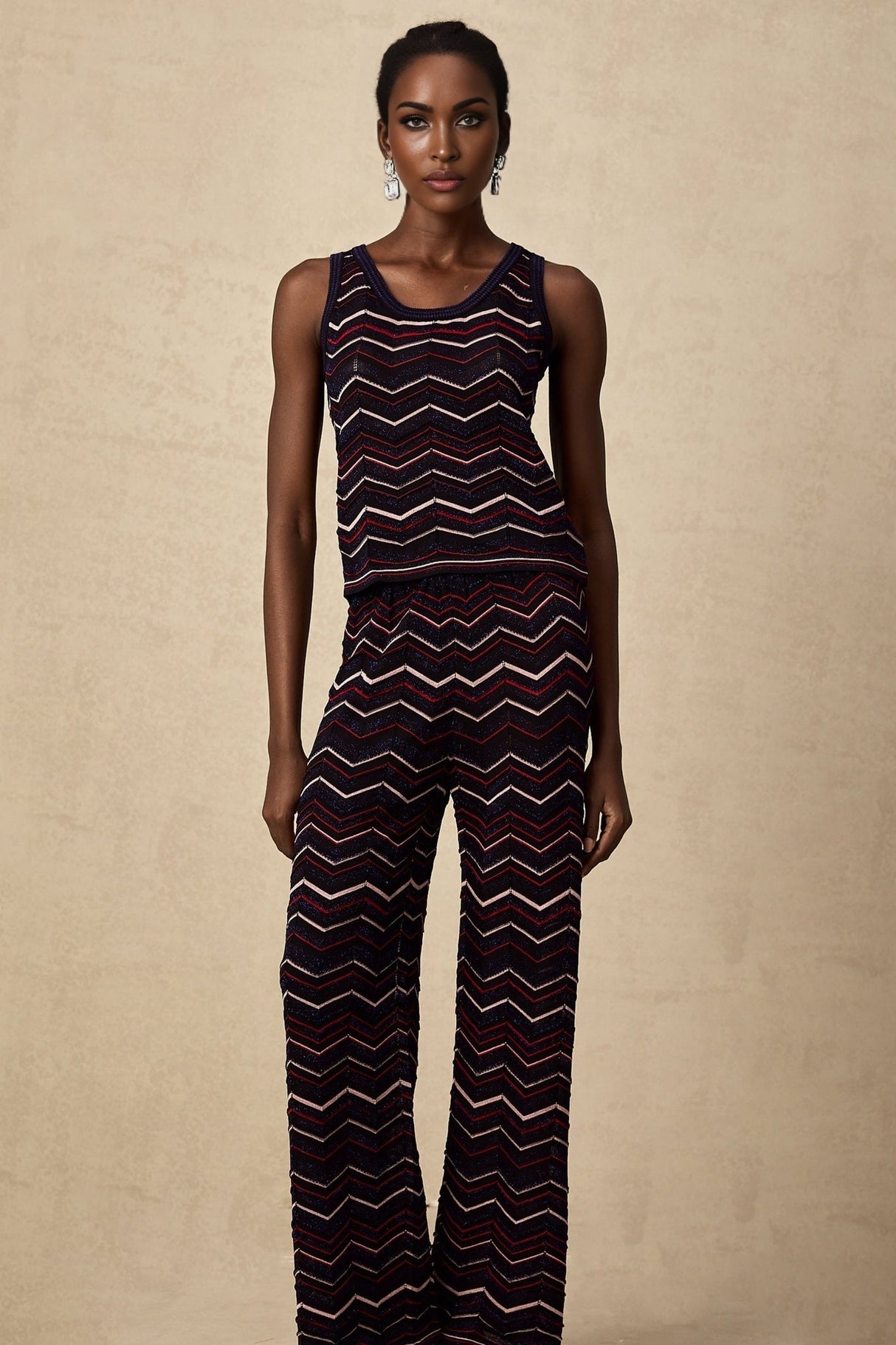 Woman wearing matching crochet knit top and trousers with zigzag pattern in Emmanuelle style set