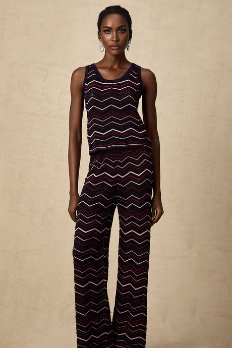 Woman wearing matching crochet knit top and trousers with zigzag pattern in Emmanuelle style set