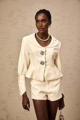 Woman wearing matching crystalembellished jacket and shorts set in Iselin style