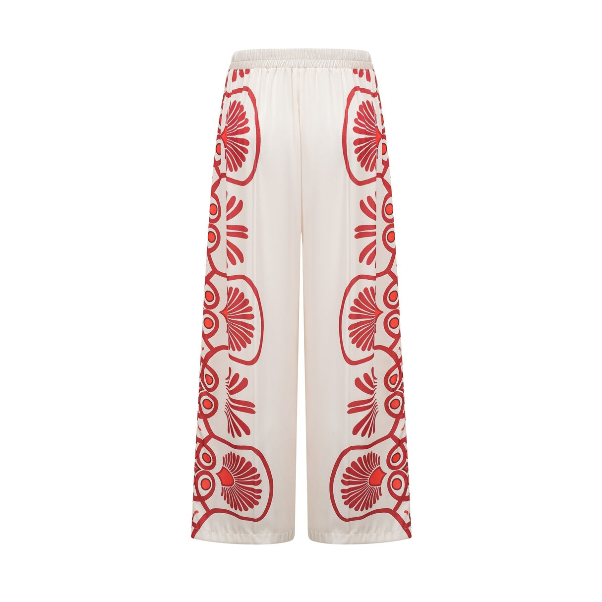 Woman wearing matching floral print shirt and trousers set in vibrant colors with Amaranta design