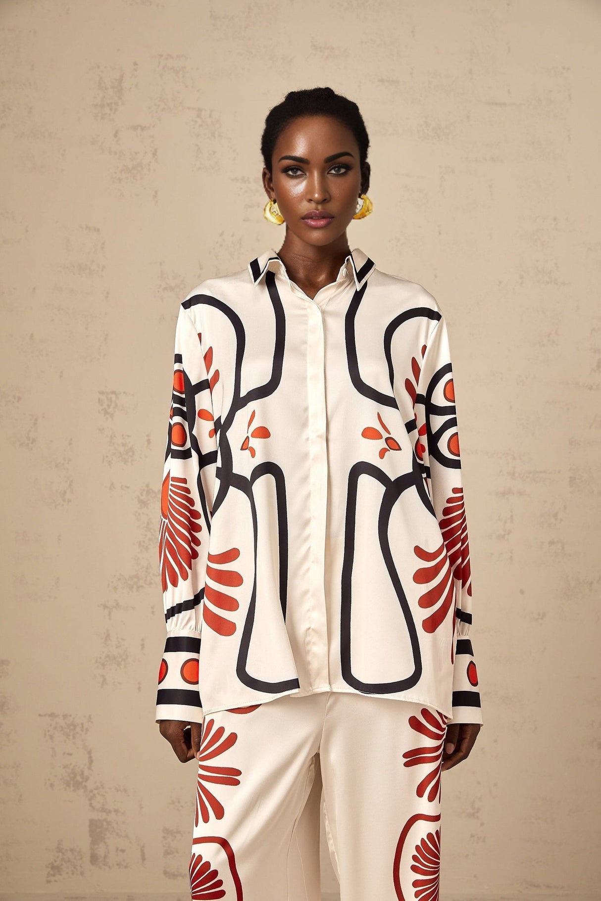 Woman wearing matching floral print shirt and trousers set in vibrant colors