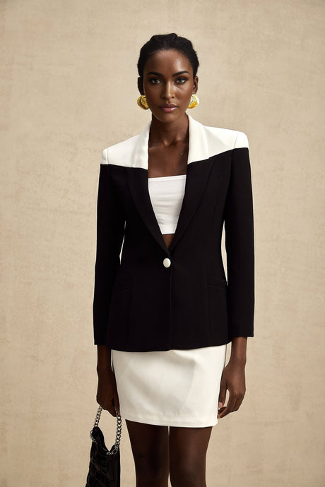 Woman wearing matching jacket and skirt set in contrasting colors fabric appears lightweight suitable for warm weather