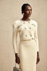 Woman wearing matching knit cardigan and skirt set with embellishments named Justine