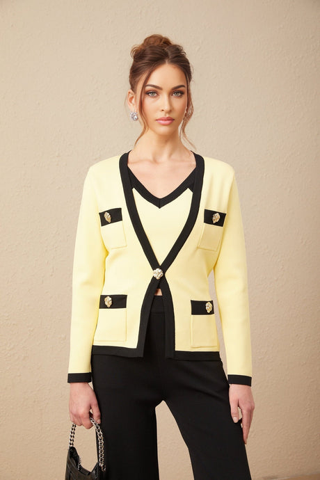 Woman wearing matching knit cardigan vest and trousers set with contrasting trim in Eloise style