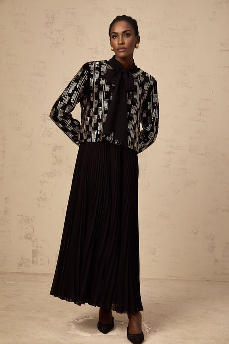 Woman wearing matching sequined cardigan and dress set in check pattern