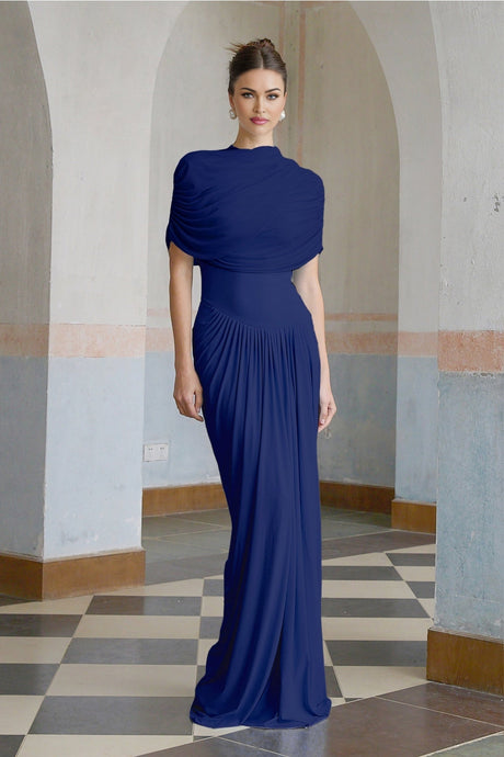 Woman wearing navy blue asymmetric pleated maxi dress with long sleeves and flowy skirt