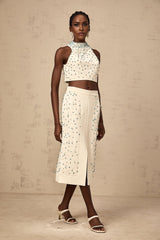 Woman wearing offwhite matching set consisting of embellished top and skirt named Clothilde