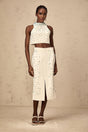 Woman wearing offwhite matching set with embellished top and skirt called Clothilde