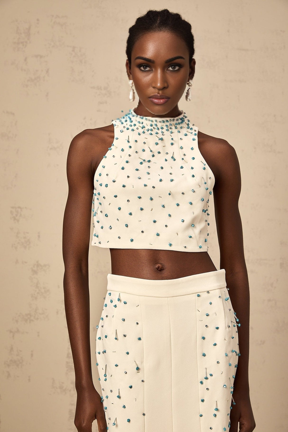 Woman wearing offwhite matching set with embellished top and skirt
