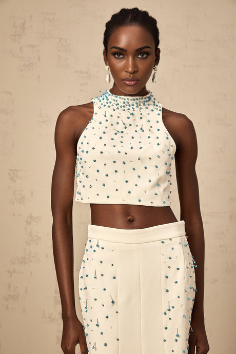 Woman wearing offwhite matching set with embellished top and skirt